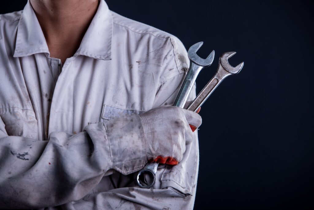 car mechanic wearing white uniform stand holding wrench 1150 16608